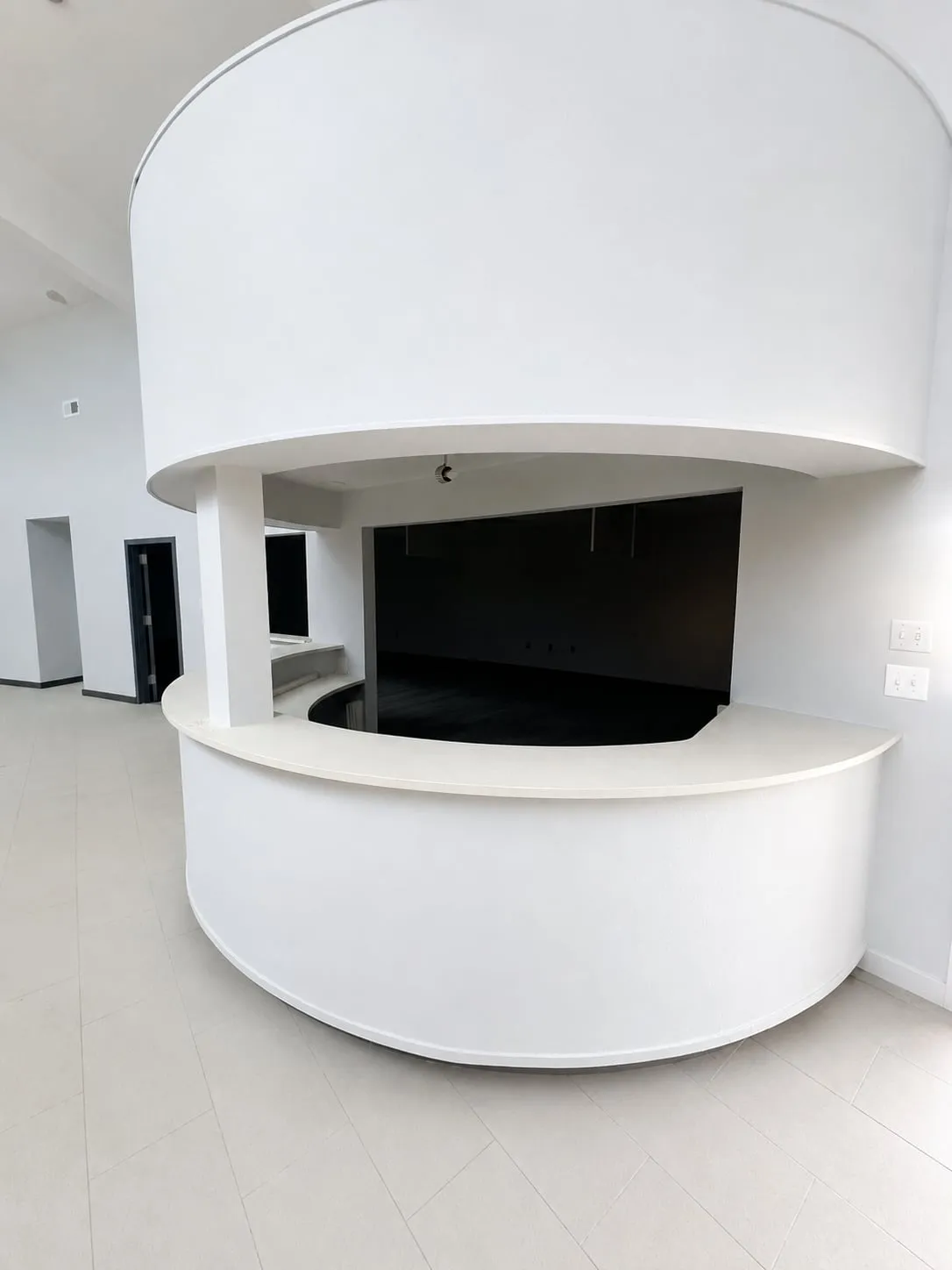Curved built-in reception desk beneath the rotunda at 125 Dillon Drive